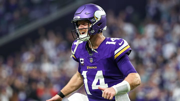 Dec 8, 2024; Minneapolis, Minnesota, USA; Minnesota Vikings quarterback Sam Darnold (14) celebrates running back Aaron Jones' (33) touchdown run against the Atlanta Falcons during the fourth quarter at U.S. Bank Stadium. Mandatory Credit: Matt Krohn-Imagn Images