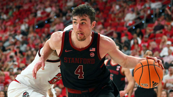 Mar 7, 2026; Raleigh, North Carolina, USA;  Stanford Cardinal forward AJ Rohosy (4) controls the ball around NC State Wolfpack forward Ven-Allen Lubin (22) during the second half at Lenovo Center. Mandatory Credit: Zachary Taft-Imagn Images