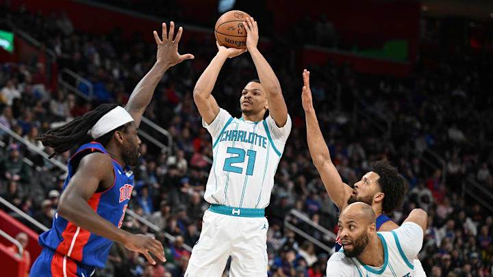 Feb 9, 2025; Detroit, Michigan, USA; Charlotte Hornets guard Isaiah Wong (21) shoots the ball over Detroit Pistons center Isaiah Stewart (28)  in the fourth quarter at Little Caesars Arena. Mandatory Credit: Lon Horwedel-Imagn Images