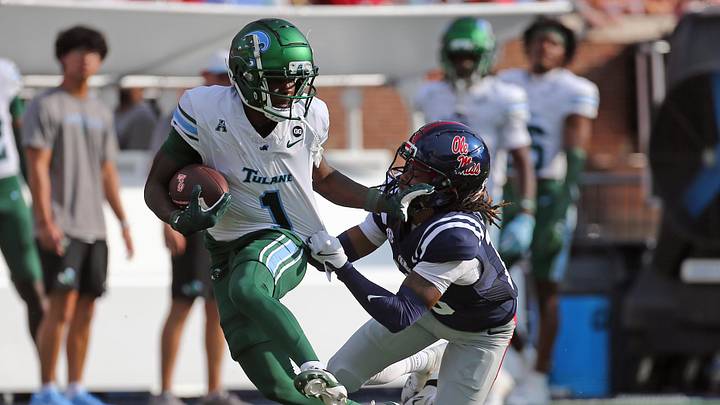 Sep 20, 2025; Oxford, Mississippi, USA; Tulane Green Wave wide receiver Omari Hayes (1) runs after a catch as Mississippi Rebels defensive back Cedrick Beavers (13) makes the tackle during the third quarter at Vaught-Hemingway Stadium. Mandatory Credit: Petre Thomas-Imagn Images