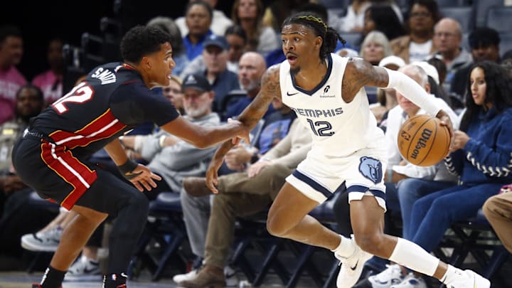 Oct 18, 2024; Memphis, Tennessee, USA; Memphis Grizzlies guard Ja Morant (12) dribbles as Miami Heat guard Dru Smith (12) defends during the first half at FedExForum. Mandatory Credit: Petre Thomas-Imagn Images Oct 18, 2024; Memphis, Tennessee, USA; Memphis Grizzlies guard Ja Morant (12) dribbles as Miami Heat guard Dru Smith (12) defends during the first half at FedExForum. Mandatory Credit: Petre Thomas-Imagn Images