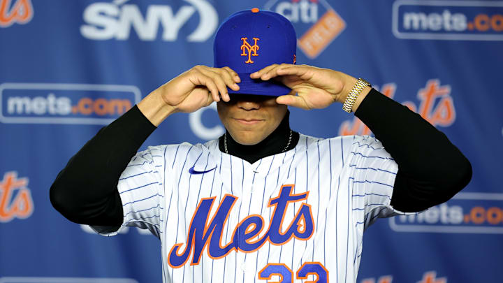 Dec 12, 2024; Flushing, NY, USA; New York Mets right fielder Juan Soto puts on a Mets cap during his introductory press conference at Citi Field. Mandatory Credit: Brad Penner-Imagn Images Dec 12, 2024; Flushing, NY, USA; New York Mets right fielder Juan Soto puts on a Mets cap during his introductory press conference at Citi Field. Mandatory Credit: Brad Penner-Imagn Images