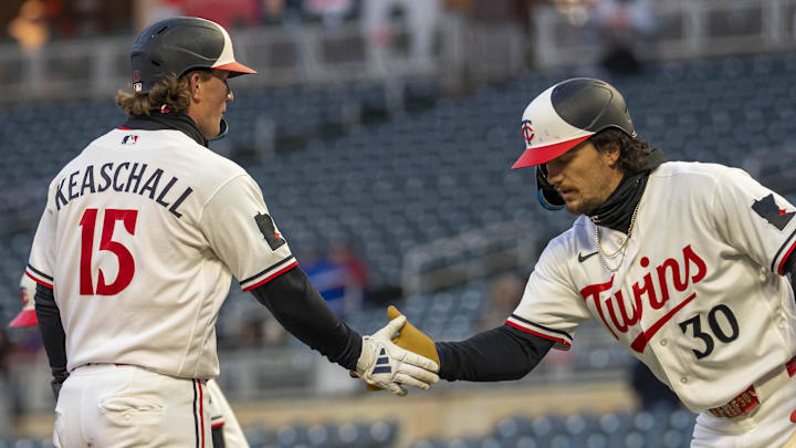 Apr 6, 2026; Minneapolis, Minnesota, USA; Minnesota Twins second baseman Luke Keaschall (15) shakes hands with center fielder James Outman (30) after scoring a run against the Detroit Tigers in the third inning at Target Field. Mandatory Credit: Jesse Johnson-Imagn Images
