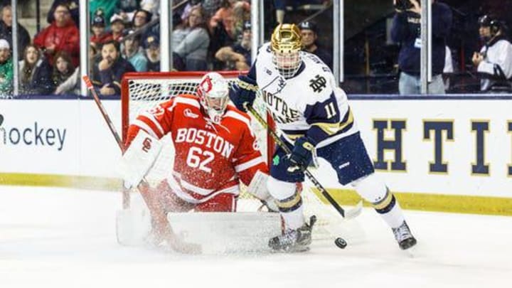 Notre Dame forward Danny Nelson (11) looks to shoot the puck on Boston University goaltender Mathieu