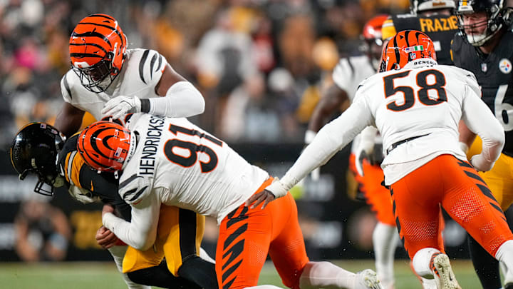 Cincinnati Bengals defensive end Trey Hendrickson (91) sacks Pittsburgh Steelers quarterback Russell Wilson (3) in the first quarter of the NFL Week 18 game between the Pittsburgh Steelers and the Cincinnati Bengals at Acrisure Stadium in Pittsburgh on Saturday, Jan. 4, 2025.