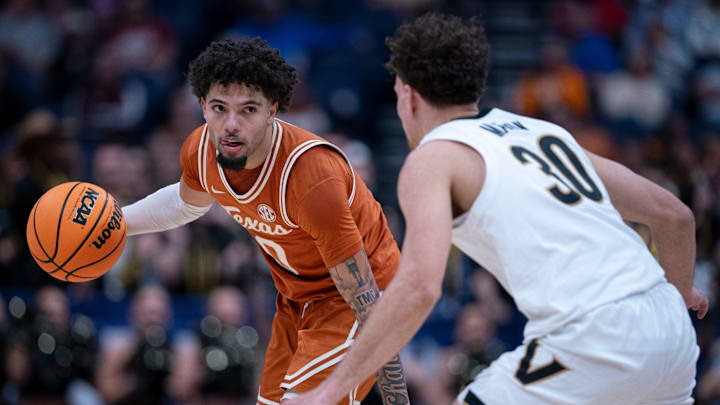 Texas Longhorns guard Jordan Pope (0) brings the ball up court against Vanderbilt Commodores guard Chris Manon (30) during their first round game of the SEC Men's Basketball Tournament at Bridgestone Arena in Nashville, Tenn., Wednesday, March 12, 2025. Texas Longhorns guard Jordan Pope (0) brings the ball up court against Vanderbilt Commodores guard Chris Manon (30) during their first round game of the SEC Men's Basketball Tournament at Bridgestone Arena in Nashville, Tenn., Wednesday, March 12, 2025.