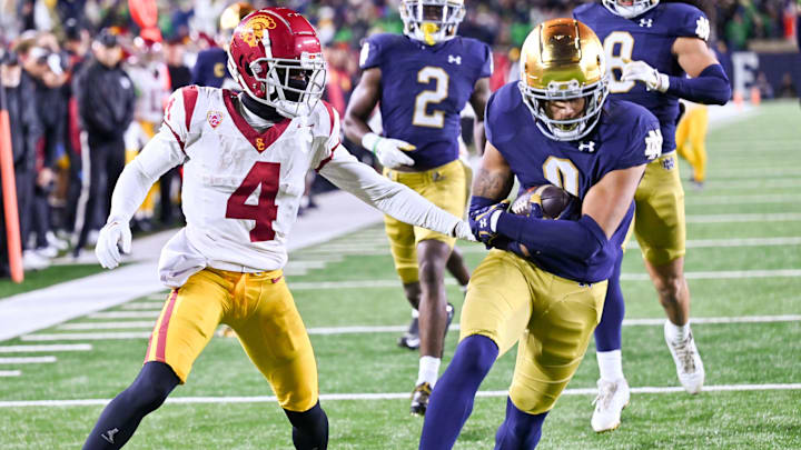 Oct 14, 2023; South Bend, Indiana, USA; Notre Dame Fighting Irish safety Xavier Watts (0) scores a touchdown in front of USC Trojans wide receiver Mario Williams (4) after a fumble recovery in the fourth quarter at Notre Dame Stadium. Notre Dame won 48-20. Oct 14, 2023; South Bend, Indiana, USA; Notre Dame Fighting Irish safety Xavier Watts (0) scores a touchdown in front of USC Trojans wide receiver Mario Williams (4) after a fumble recovery in the fourth quarter at Notre Dame Stadium. Notre Dame won 48-20.
