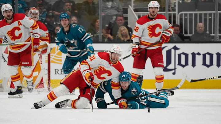 Apr 9, 2024; San Jose, California, USA; Calgary Flames center Kevin Rooney (21) battles San Jose
