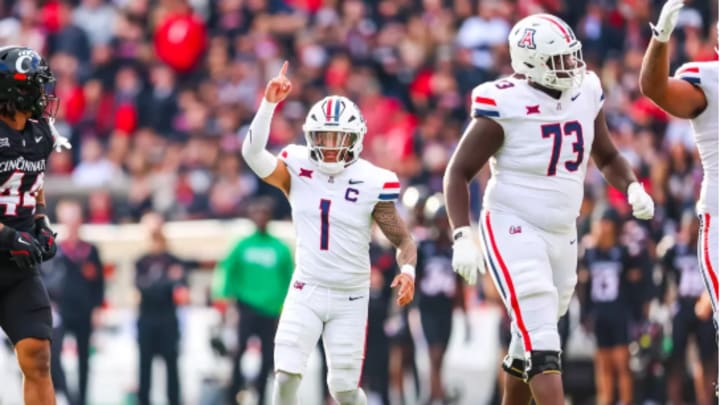Matthew Lado alongside Niah Fifita during a successful drive against Cincinnati