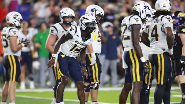 West Virginia Mountaineers quarterback Khalil Wilkins (14) makes calls during the second half of the game against Kansas Jayhawks at David Booth Kansas Memorial Stadium on Sept. 20, 2025.