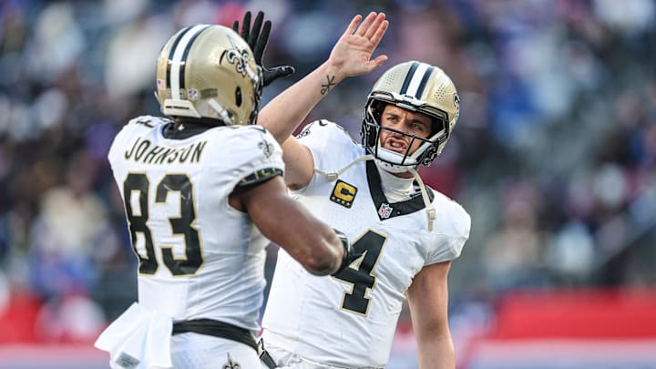 Dec 8, 2024; East Rutherford, New Jersey, USA; New Orleans Saints tight end Juwan Johnson (83) celebrates his touchdown reception from quarterback Derek Carr (4) during the second half against the New York Giants at MetLife Stadium. Mandatory Credit: Vincent Carchietta-Imagn Images Dec 8, 2024; East Rutherford, New Jersey, USA; New Orleans Saints tight end Juwan Johnson (83) celebrates his touchdown reception from quarterback Derek Carr (4) during the second half against the New York Giants at MetLife Stadium. Mandatory Credit: Vincent Carchietta-Imagn Images