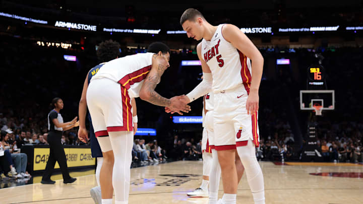 Dec 29, 2025; Miami, Florida, USA; Miami Heat forward Nikola Jovic (5) and center Kel'El Ware (7) shake hands during the third quarter against the Denver Nuggets at Kaseya Center. Mandatory Credit: Sam Navarro-Imagn Images