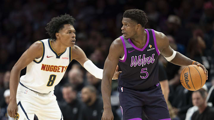Nov 15, 2025; Minneapolis, Minnesota, USA; Minnesota Timberwolves guard Anthony Edwards (5) dribbles the Ball as Denver Nuggets guard Peyton Watson (8) plays defense in the second half at Target Center.