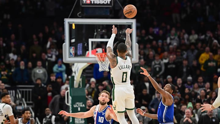 Jan 14, 2024; Milwaukee, Wisconsin, USA; Milwaukee Bucks guard Damian Lillard (0) scores the game-winning three-point basket at the end of overtime against the Sacramento Kings at Fiserv Forum. Mandatory Credit: Benny Sieu-Imagn Images