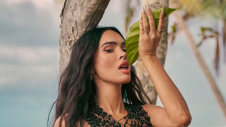 Megan Fox was photographed by Greg Swales in the Dominican Republic. Swimsuit by Bareminimale. Top by YVY. Earrings by Jacquie Aiche.