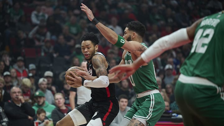 Mar 23, 2025; Portland, Oregon, USA;  Portland Trail Blazers guard Anfernee Simons (1) dribbles the ball during the first half against Boston Celtics forward Jayson Tatum (0) at Moda Center. Mandatory Credit: Troy Wayrynen-Imagn Images