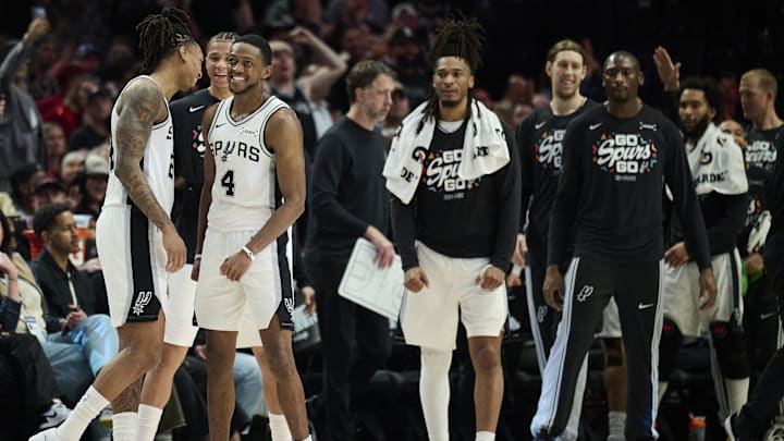 Apr 26, 2026; Portland, Oregon, USA; San Antonio Spurs guard Devin Vassell (24) and guard De'aaron Fox (4) celebrate during a break in the game during the second half against the Portland Trail Blazers during game four of the first round of the 2026 NBA Playoffs at Moda Center. Mandatory Credit: Troy Wayrynen-Imagn Images