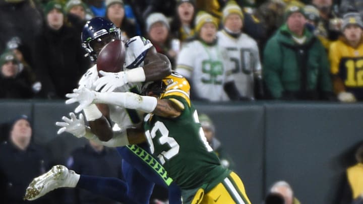 Green Bay Packers cornerback Jaire Alexander (23) breaks up a pass intended for Seattle Seahawks wide receiver D.K. Metcalf.