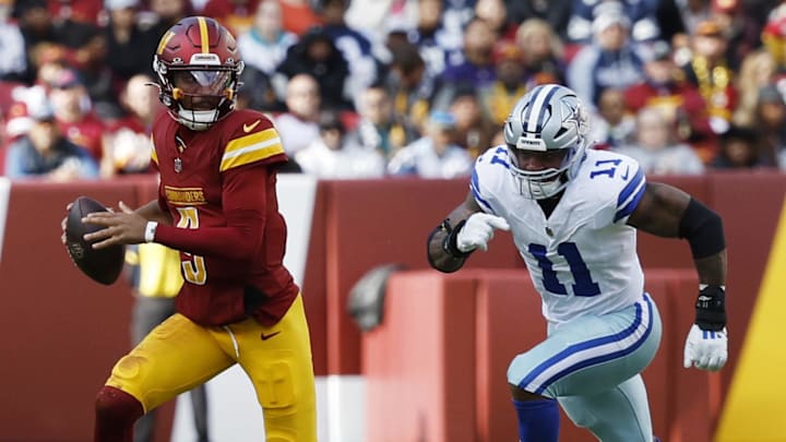 Nov 24, 2024; Landover, Maryland, USA; Washington Commanders quarterback Jayden Daniels (5) scrambles from Dallas Cowboys linebacker Micah Parsons (11) at Northwest Stadium. Mandatory Credit: Geoff Burke-Imagn Images