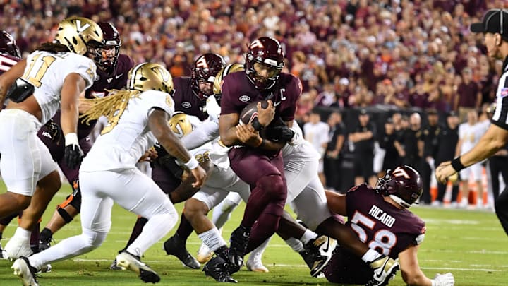 Sep. 6, 2025; Blacksburg, Va.; Virginia Tech quarterback Kyron Drones (1) runs through the line as Vanderbilt safety CJ Heard (8) pursues.