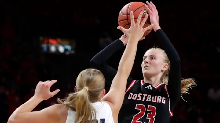 Oostburg High School's Kinsley Ketterhagen (23) shoots the ball against Xavier's Ali Tylinski (21) during the WIAA Division 3 girls basketball state championship game on March 15, 2025.