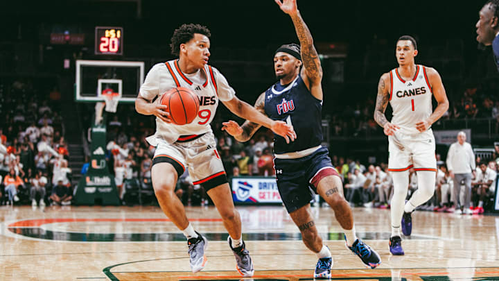 Divine  Ugochukwu (99) looking for to pass to Lynn Kidd (1) during Miami's season opener against FDU.