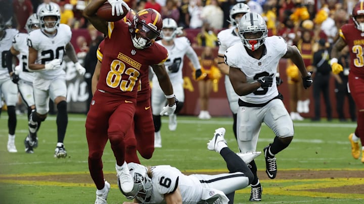 Sep 21, 2025; Landover, Maryland, USA; Washington Commanders wide receiver Jaylin Lane (83) returns a punt for a touchdown past Las Vegas Raiders punter AJ Cole (6) during the third quarter at Northwest Stadium. Mandatory Credit: Geoff Burke-Imagn Images