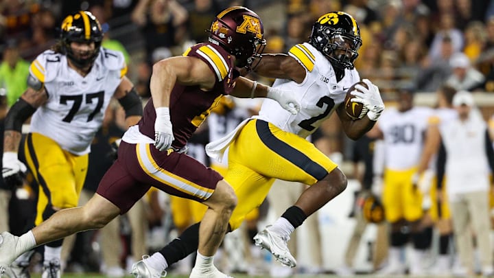Sep 21, 2024; Minneapolis, Minnesota, USA; Iowa Hawkeyes running back Kaleb Johnson (2) runs the ball resulting in a touchdown as Minnesota Golden Gophers defensive back Coleman Bryson (16) defends during the second half at Huntington Bank Stadium. Mandatory Credit: Matt Krohn-Imagn Images