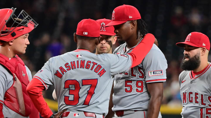 Jun 12, 2024; Phoenix, Arizona, USA; Los Angeles Angels manager Ron Washington (37) talks with pitcher José Soriano (59) in the eighth inning against the Arizona Diamondbacks at Chase Field. Mandatory Credit: Matt Kartozian-USA TODAY Sports