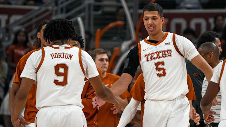 Texas Longhorns forward Kadin Shedrick (5) celebrates with guard Ithiel Horton (9) during a timeout