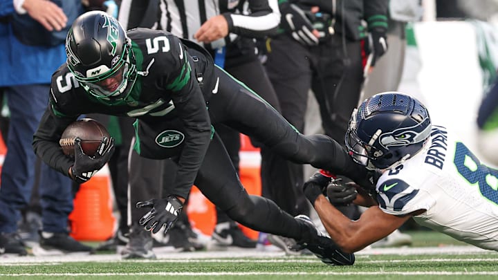 Dec 1, 2024; East Rutherford, New Jersey, USA; New York Jets wide receiver Garrett Wilson (5) fights for yards as Seattle Seahawks cornerback Coby Bryant (8) tackles during the second half at MetLife Stadium. Dec 1, 2024; East Rutherford, New Jersey, USA; New York Jets wide receiver Garrett Wilson (5) fights for yards as Seattle Seahawks cornerback Coby Bryant (8) tackles during the second half at MetLife Stadium.