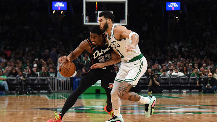 Dec 28, 2023; Boston, Massachusetts, USA;  Detroit Pistons guard Jaden Ivey (23) controls the ball while Boston Celtics forward Jayson Tatum (0) defends during the second half at TD Garden. Mandatory Credit: Bob DeChiara-Imagn Images