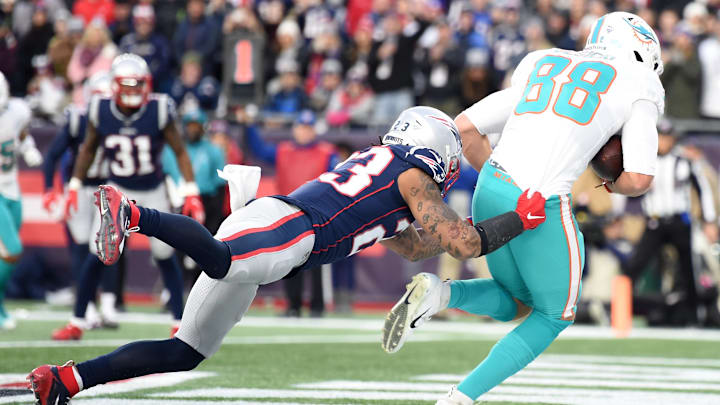 Miami Dolphins tight end Mike Gesicki (88) makes a catch for a touchdown past New England Patriots strong safety Patrick Chung (23) during the second half at Gillette Stadium in the 2019 season finale.