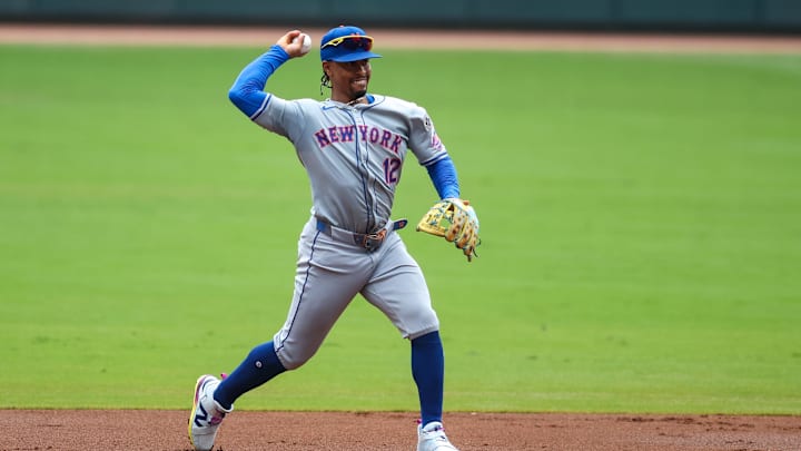 Sep 30, 2024; Atlanta, Georgia, USA; New York Mets shortstop Francisco Lindor (12) throws a runner out at first against the Atlanta Braves in the first inning at Truist Park. Mandatory Credit: Brett Davis-Imagn Images