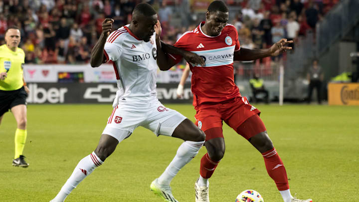 Prince Owusu #99 (L) and Carlos Terán #4 (R) seen in action...