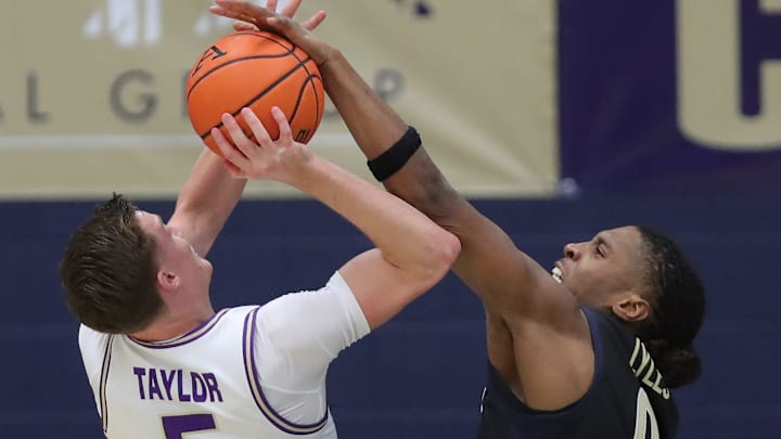 Akron Zips forward Amani Lyles (0) blocks a shot by James Madison Dukes forward Justin Taylor (5) on Nov. 3, 2025, in Akron.