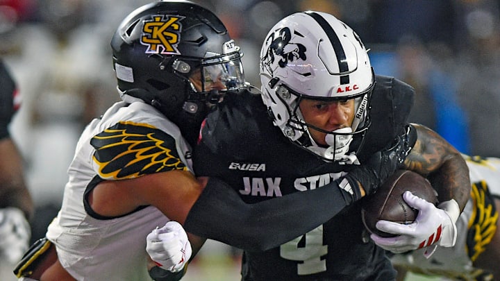 Jax State's Cam Cook tries to evade the tackle of Kennesaw State's Alexander Ford during the C-USA Championship at AmFirst Stadium in Jacksonville, Alabama December 5, 2025. (Dave Hyatt / Hyatt Media LLC)