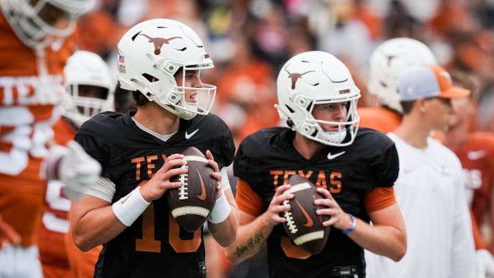 Texas Longhorns quarterbacks Arch Manning (16), left, and Quinn Ewers (3) throw passes while warming up ahead of the Longhorns' spring Orange and White game at Darrell K Royal Texas Memorial Stadium in Austin, Texas, April 20, 2024.