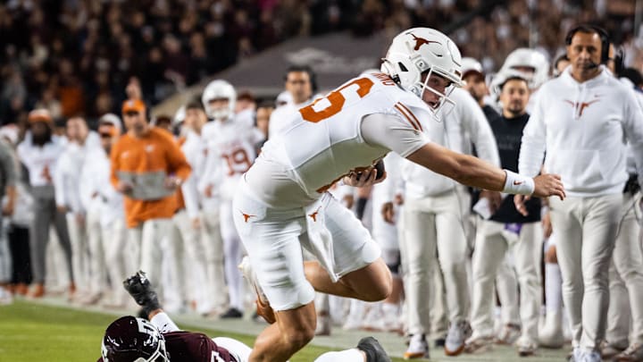 Nov 30, 2024; College Station, Texas, USA; Texas Longhorns quarterback Arch Manning (16) evades Texas A&M Aggies defensive back Marcus Ratcliffe (3) to run the ball in for the first touchdown in the first quarter at Kyle Field. Mandatory Credit: Sara Diggins/USA TODAY Network via Imagn Images