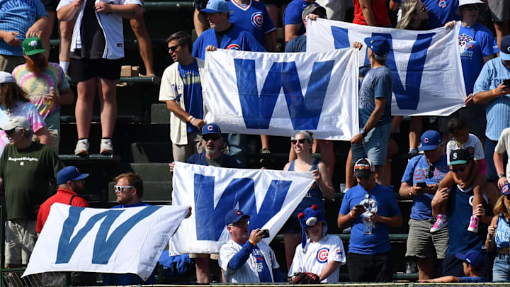 Aug 22, 2024; Chicago, Illinois, USA; Chicago Cubs fans hold up W flags after their team defeats the Detroit Tigers at Wrigley Field. Aug 22, 2024; Chicago, Illinois, USA; Chicago Cubs fans hold up W flags after their team defeats the Detroit Tigers at Wrigley Field.