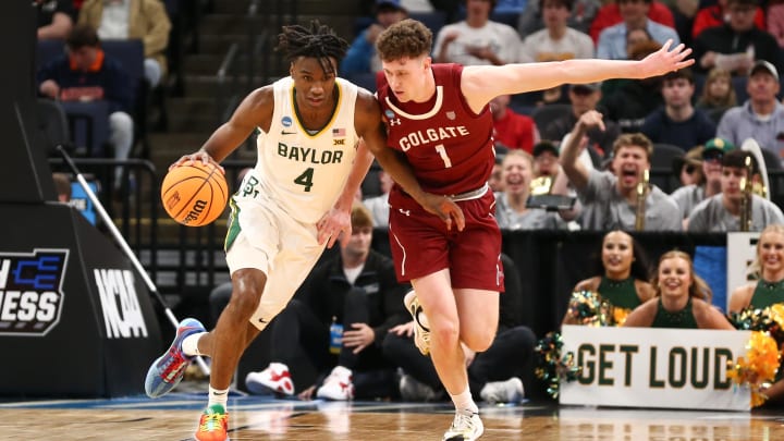 Mar 22, 2024; Memphis, TN, USA; Baylor Bears guard Ja'Kobe Walter (4) dribbles against Colgate Raiders guard Brady Cummins (1) during the first half of the NCAA Tournament First Round at FedExForum. Mandatory Credit: Petre Thomas-USA TODAY Sports