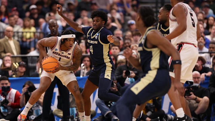Mar 20, 2026; Tampa, FL, USA; Akron Zips guard Eric Mahaffey (4) defends Texas Tech Red Raiders guard Tyeree Bryan (1) in the second half during a first round game of the men's 2026 NCAA Tournament at Benchmark International Arena. Mandatory Credit: Matt Pendleton-Imagn Images