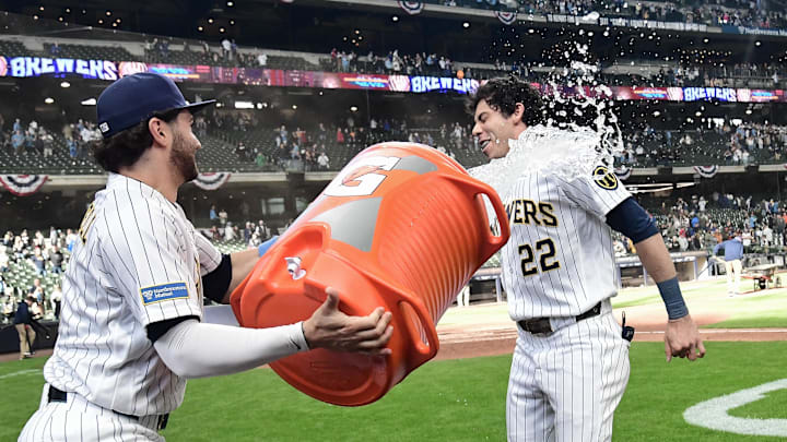 Mar 29, 2026; Milwaukee, Wisconsin, USA;  Milwaukee Brewers designated hitter Christian Yelich (22) gets dunked by center fielder Garrett Mitchell (5) after beating the Chicago White Sox at American Family Field. Mandatory Credit: Benny Sieu-Imagn Images