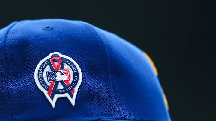 A patch remembering the September 11th terrorist attacks is seen on a Seattle Mariners hat during the game against the Atlanta Braves at T-Mobile Park in 2022.