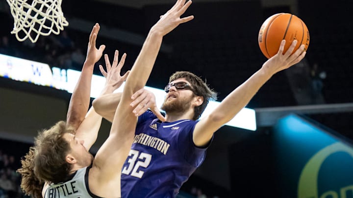 The Huskies' Wilhelm Breidenbach shoots over Oregon center Nate Bittle.