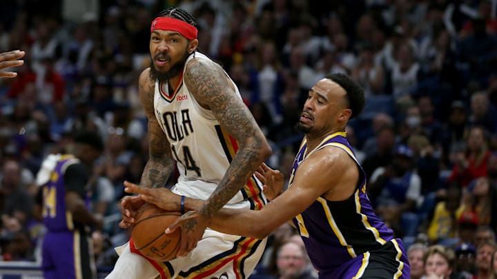 Mar 27, 2022; New Orleans, Louisiana, USA; New Orleans Pelicans forward Brandon Ingram (14) is defended by Los Angeles Lakers guard Talen Horton-Tucker (5) in the second half at the Smoothie King Center. The Pelicans won, 116-108. Mandatory Credit: Chuck Cook-Imagn Images