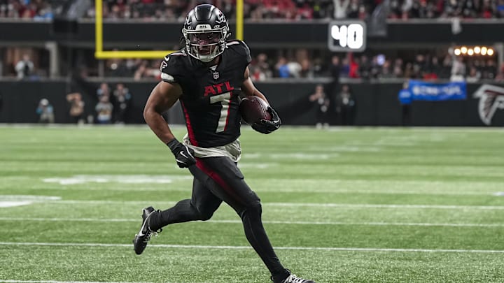 Jan 5, 2025; Atlanta, Georgia, USA; Atlanta Falcons running back Bijan Robinson (7) runs for a touchdown against the Carolina Panthers during the second half at Mercedes-Benz Stadium.
