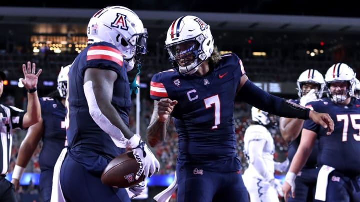 Sep 2, 2023; Tucson, Arizona, USA; Arizona Wildcats quarterback Jayden de Laura (7) celebrates a touchdown with running back Jonah Coleman (3) against the Northern Arizona Lumberjacks during the first half at Arizona Stadium.