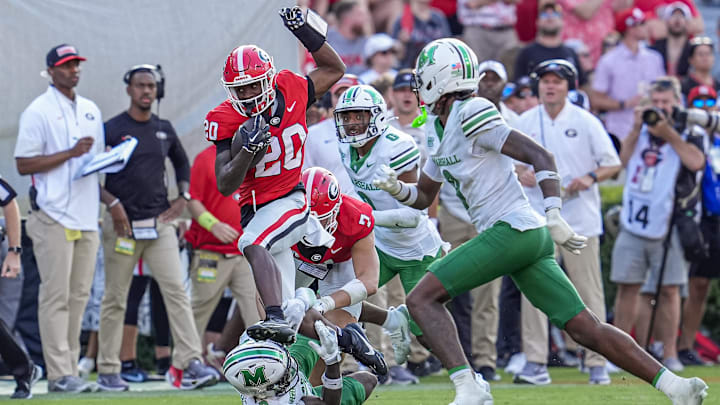 Aug 30, 2025; Athens, Georgia, USA; Georgia Bulldogs running back Dwight Phillips Jr (20) runs against Marshall Thundering Herd defensive back Marvae Myers (3) at Sanford Stadium. Mandatory Credit: Dale Zanine-Imagn Images