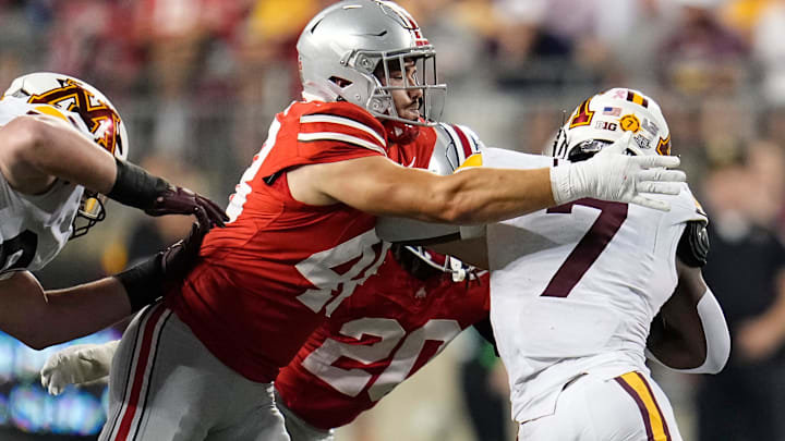 Ohio State Buckeyes defensive lineman Logan George (48) tackles Minnesota Golden Gophers running back Fame Ijeboi (7) during the NCAA football game at Ohio Stadium in Columbus on Oct. 4, 2025.